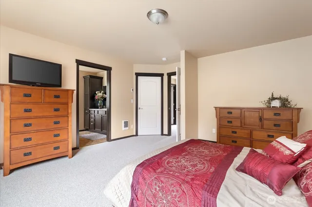 a bedroom with a bed and flat screen tv