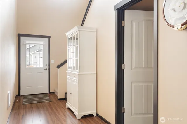 a view of a hallway with wooden floor and entryway