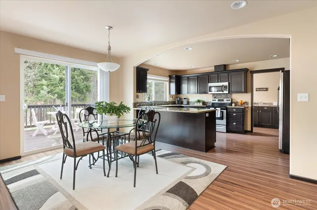 a view of a dining room with furniture window and wooden floor