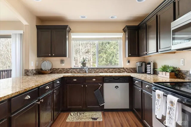 a kitchen with a sink stove top oven and cabinets