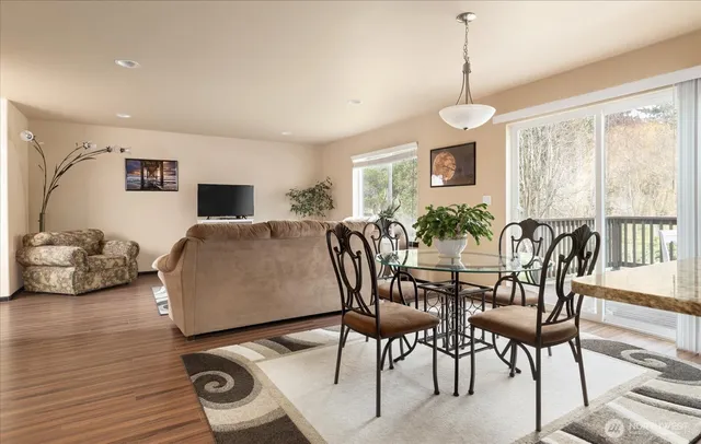a view of a dining room with furniture window and wooden floor