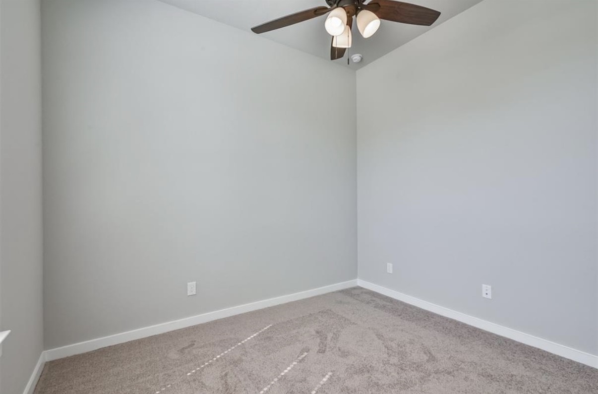 10005 Red Beadtree Place Conroe, TX 77385 - Photo 18 of 29 an empty room with a chandelier fan