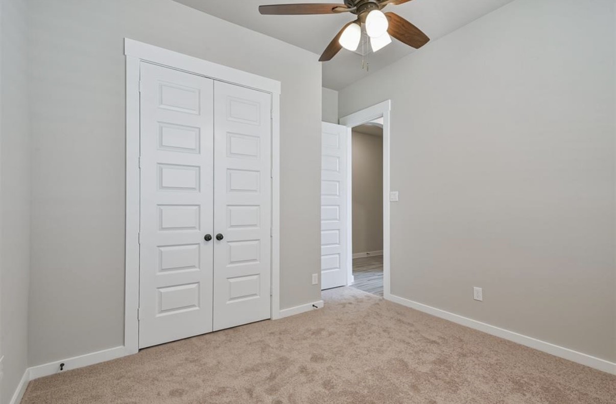 10005 Red Beadtree Place Conroe, TX 77385 - Photo 19 of 29 an empty room with closet area