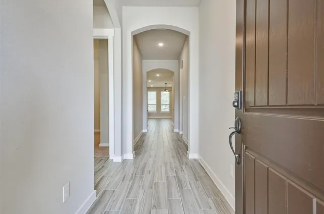 a view of a hallway with wooden floor