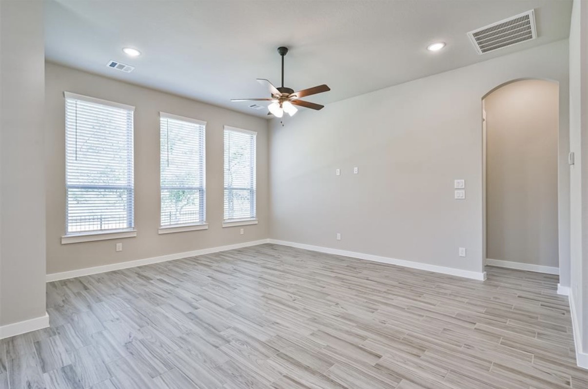10005 Red Beadtree Place Conroe, TX 77385 - Photo 6 of 29 wooden floor in an empty room with a window