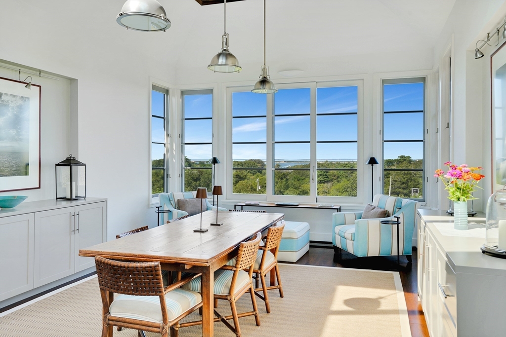 2 Squibnocket Road Chilmark, MA 02535 - Photo 15 of 42 a dining room with furniture a chandelier and a rug