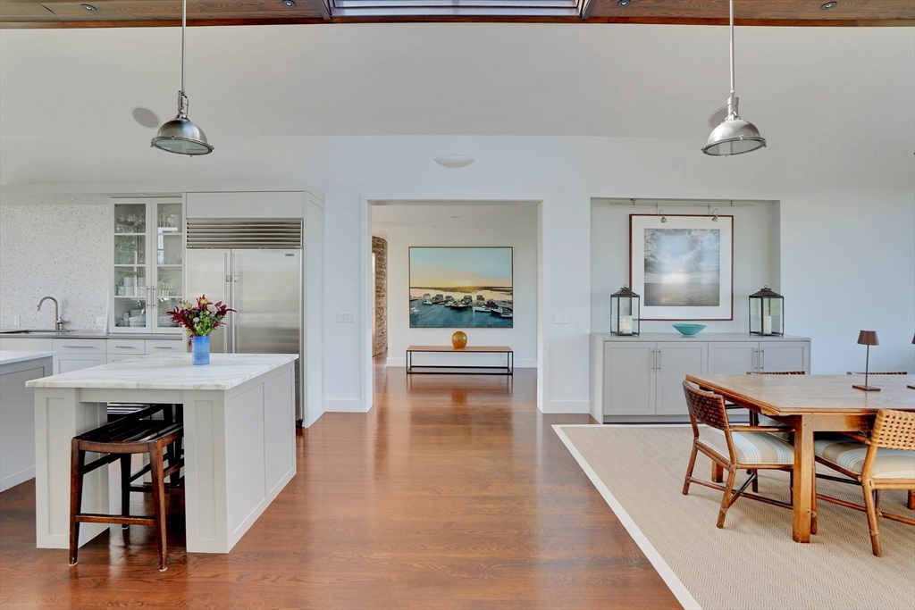 2 Squibnocket Road Chilmark, MA 02535 - Photo 17 of 42 a view of a dining room and livingroom with furniture wooden floor a chandelier