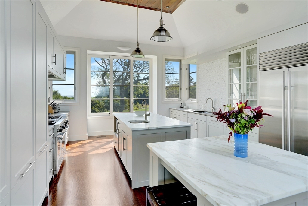 2 Squibnocket Road Chilmark, MA 02535 - Photo 19 of 42 a dining room with furniture potted plants and wooden floor