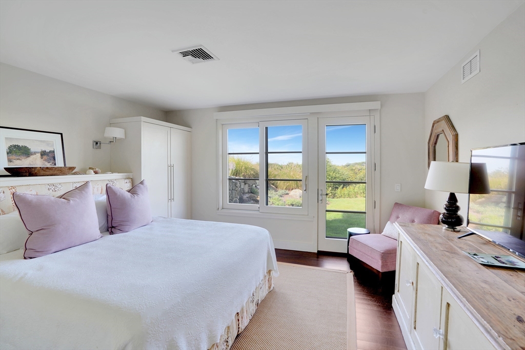 2 Squibnocket Road Chilmark, MA 02535 - Photo 32 of 42 a bedroom with a bed couch and a large window