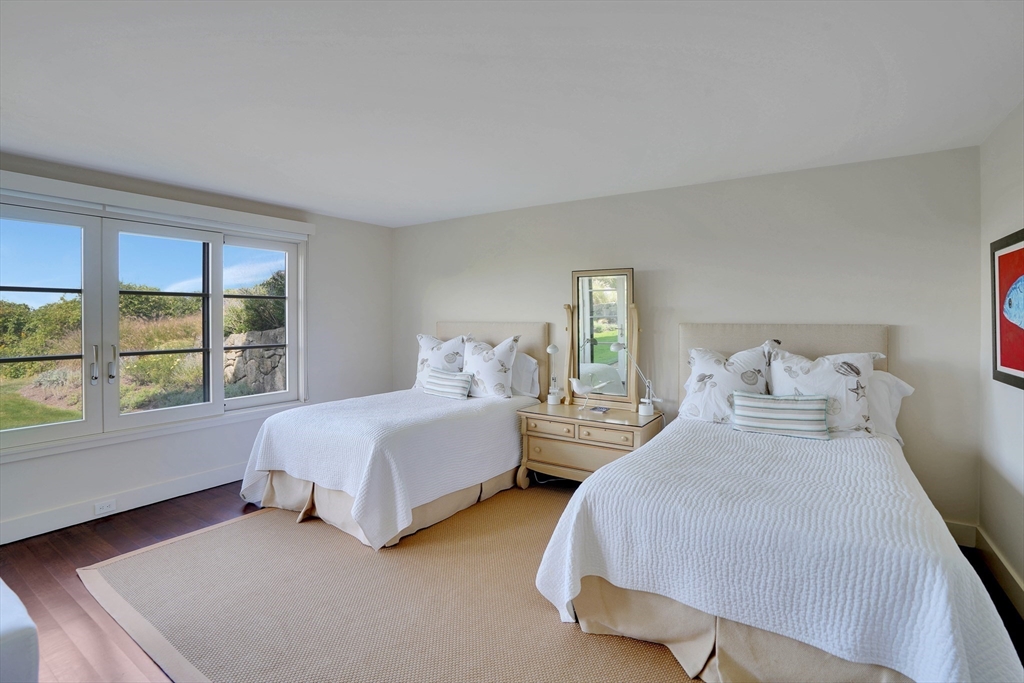 2 Squibnocket Road Chilmark, MA 02535 - Photo 33 of 42 a spacious bedroom with two beds and a large window