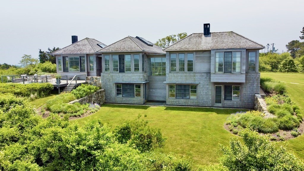 2 Squibnocket Road Chilmark, MA 02535 - Photo 8 of 42 a front view of a house with swimming pool and porch with furniture