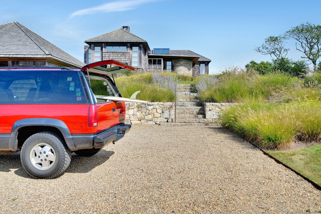2 Squibnocket Road Chilmark, MA 02535 - Photo 9 of 42 a front view of a house with garden