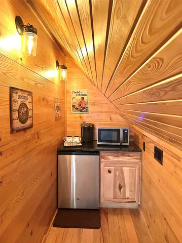 a view of a balcony with chairs and wooden floor
