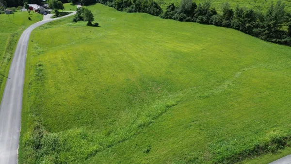 a view of a green field with clear sky
