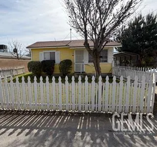 a front view of a house with a fence
