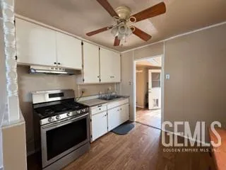 a stove top oven sitting inside of a kitchen