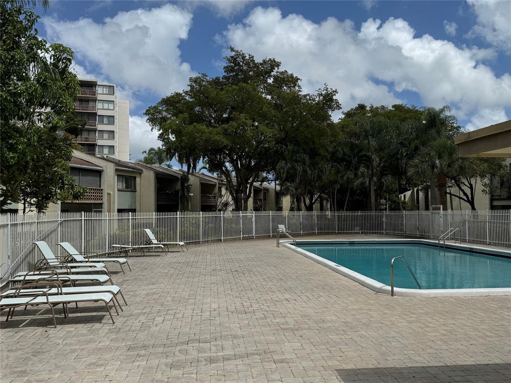 4222 Inverrary Boulevard, Unit 4711 Lauderhill, FL 33319 - Photo 3 of 11 a view of a swimming pool with a patio