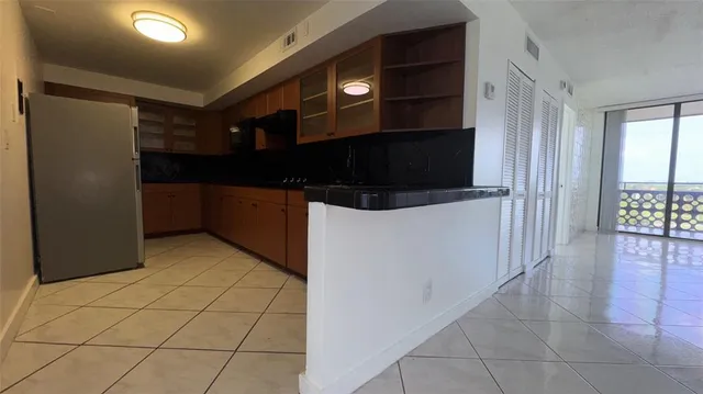 a kitchen with stainless steel appliances a refrigerator and a microwave