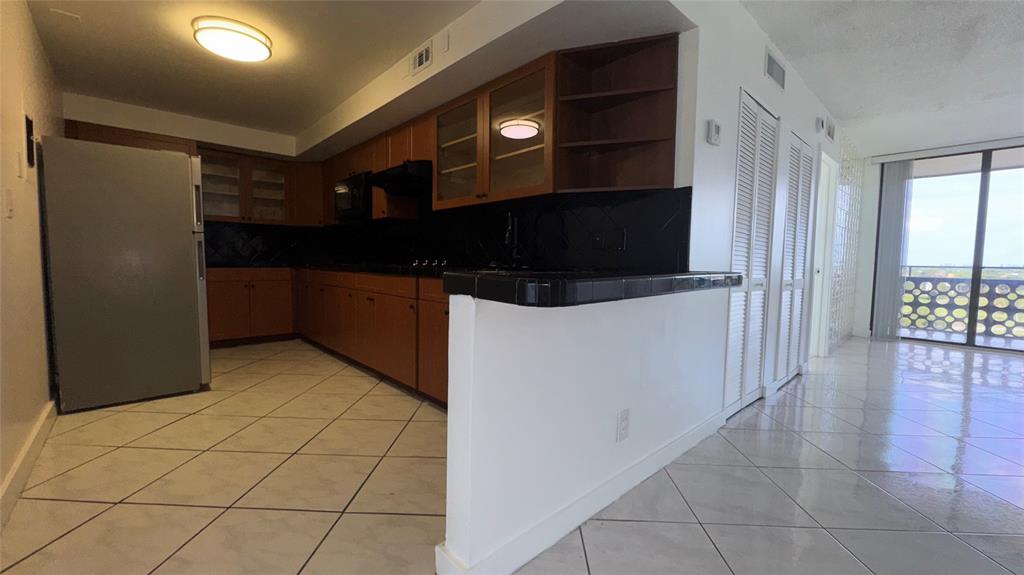 4222 Inverrary Boulevard, Unit 4711 Lauderhill, FL 33319 - Photo 10 of 11 a kitchen with stainless steel appliances a refrigerator and a microwave