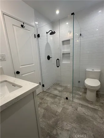 a bathroom with a sink toilet and shower