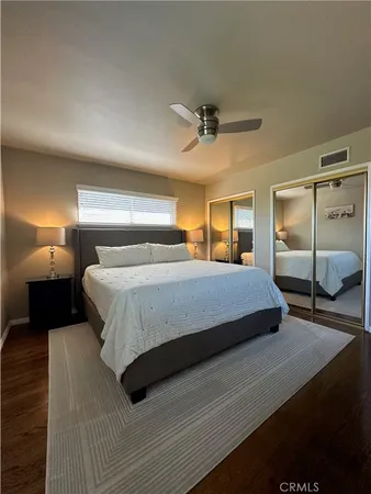 a bedroom with a bed a lamp and window