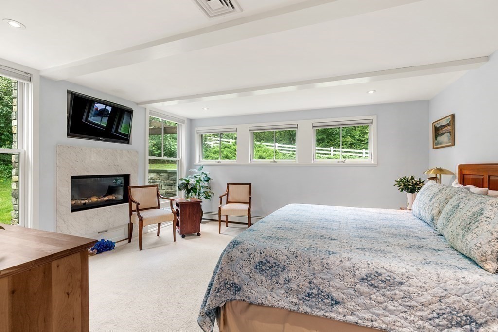 328 Dover Road Westwood, MA 02090 - Photo 16 of 41 a bedroom with a bed and a fireplace