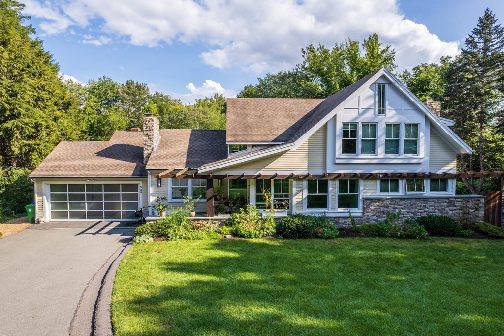 328 Dover Road Westwood, MA 02090 - Photo 38 of 41 a front view of a house with a yard table and chairs
