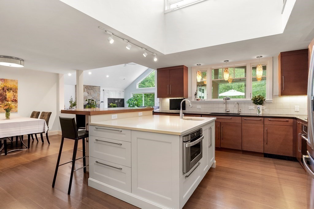 328 Dover Road Westwood, MA 02090 - Photo 8 of 41 a kitchen with stainless steel appliances granite countertop wooden floors and white cabinets
