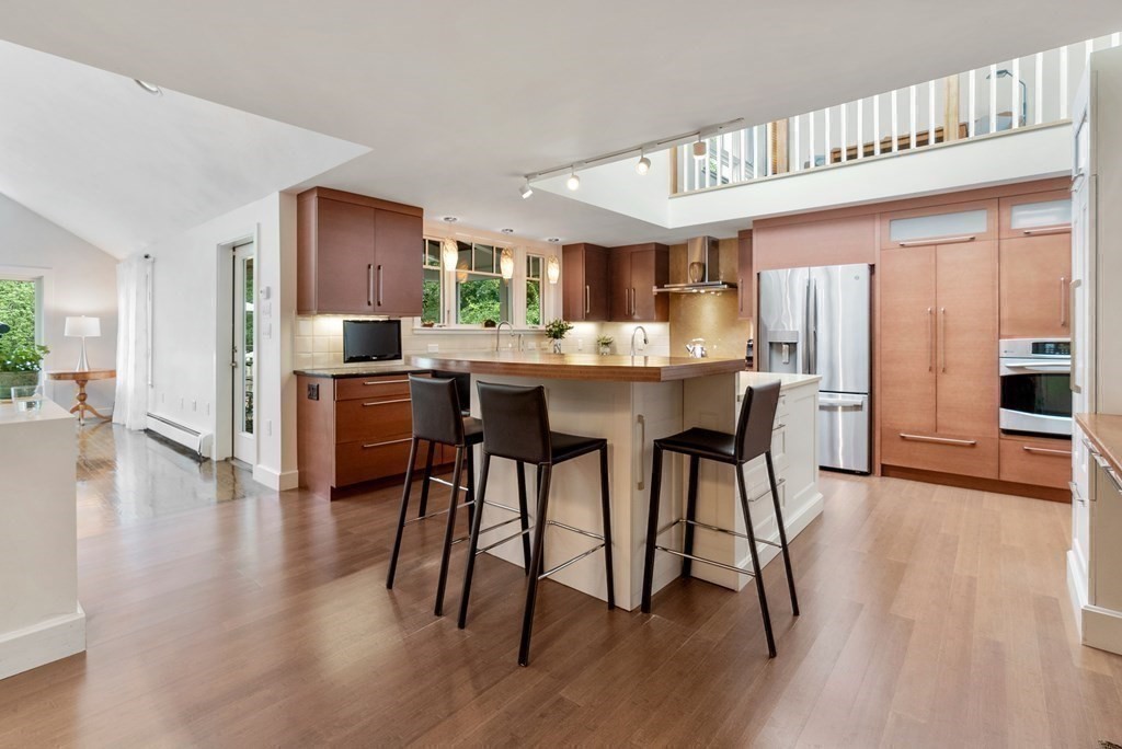 328 Dover Road Westwood, MA 02090 - Photo 10 of 41 a kitchen with stainless steel appliances granite countertop a refrigerator a stove a sink dishwasher and white cabinets with wooden floor