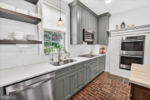 a front view of a house with a garden and plants