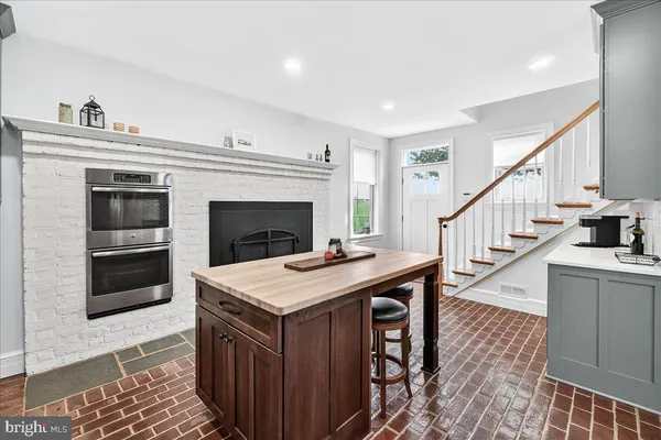 a bathroom with a double vanity sink a mirror and a shower