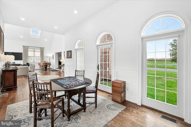 a living room with furniture a rug and a table
