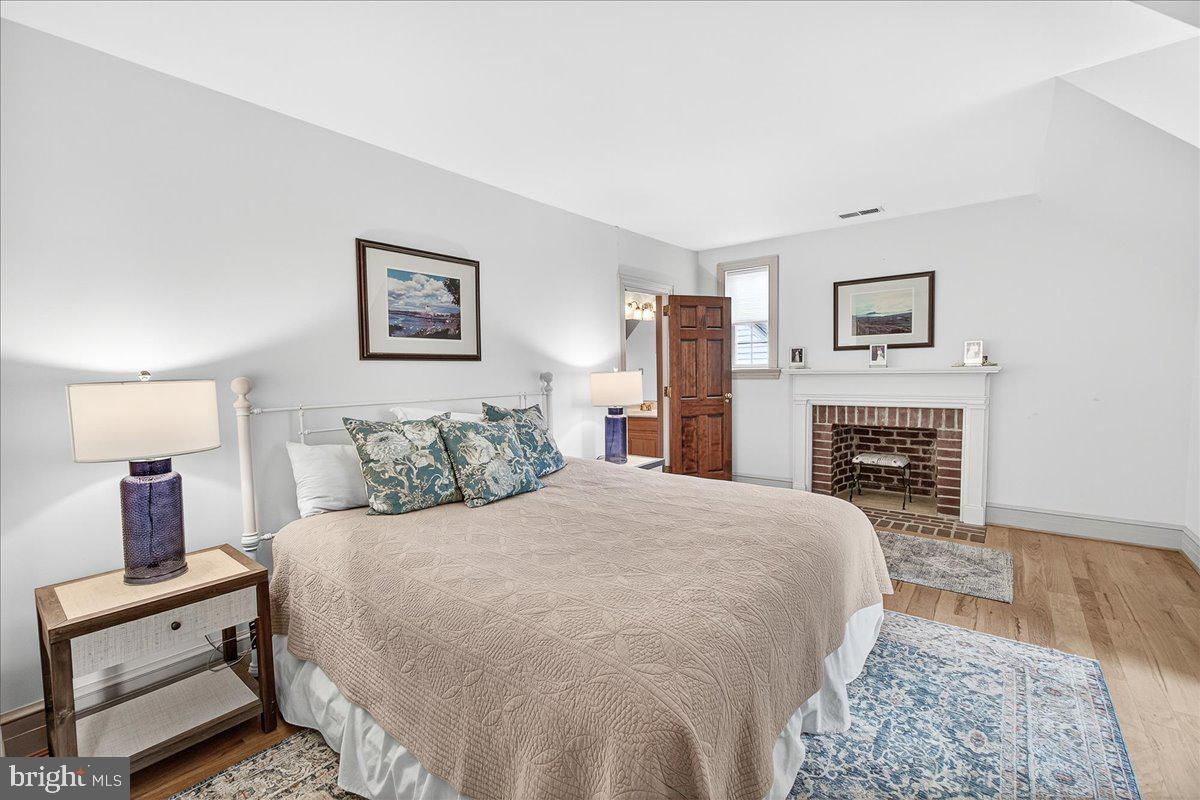 9522 Bessie Clemson Road Union Bridge, MD 21791 - Photo 47 of 107 a spacious bedroom with a bed and a fireplace