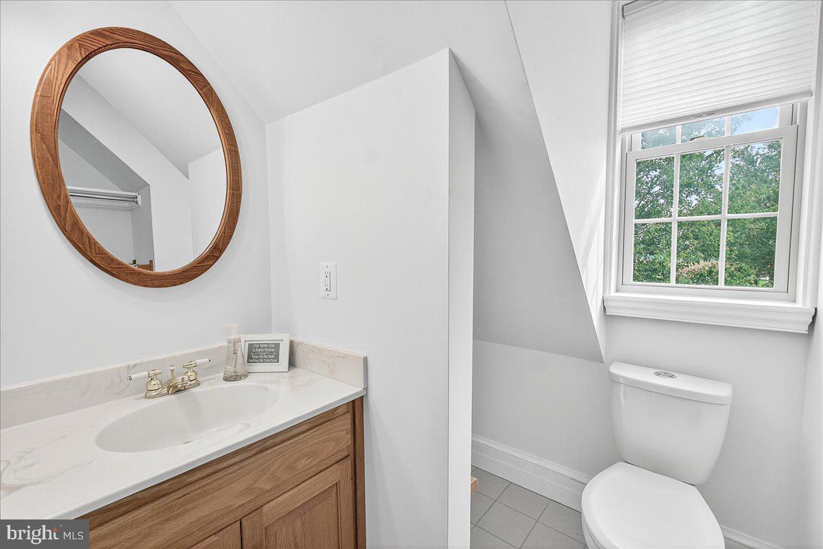 9522 Bessie Clemson Road Union Bridge, MD 21791 - Photo 58 of 107 a bathroom with a granite countertop toilet a sink and a mirror
