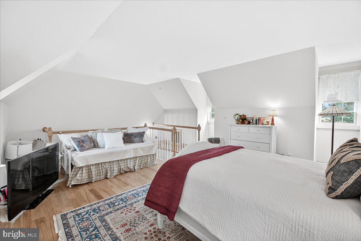 9522 Bessie Clemson Road Union Bridge, MD 21791 - Photo 60 of 107 a bed room with a bed a couch and a book shelf