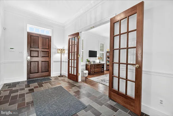 a view of a dining room with furniture wooden floor and a chandelier