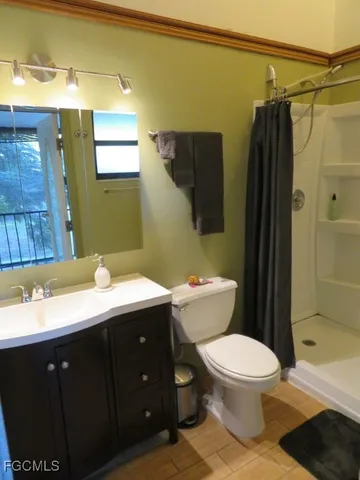 a bathroom with a toilet a sink and shower