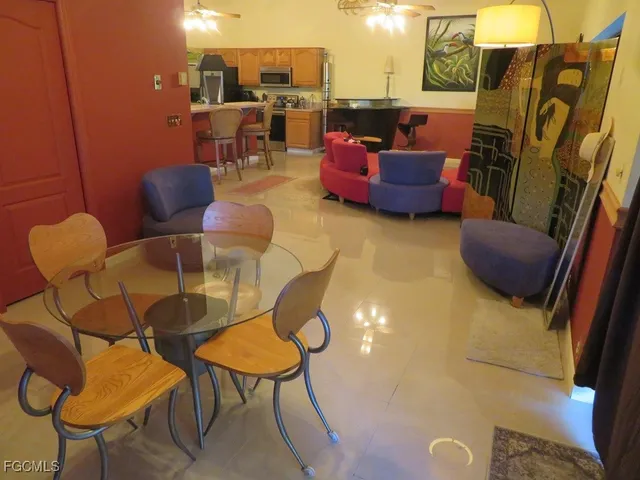 a living room with furniture and a floor to ceiling window