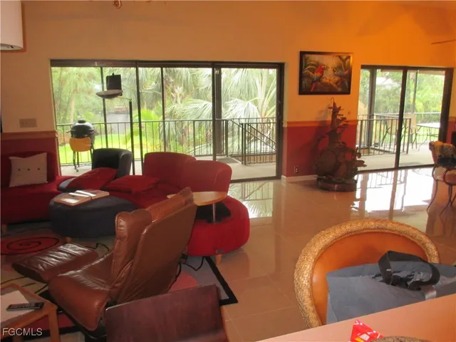 a living room with furniture and a floor to ceiling window