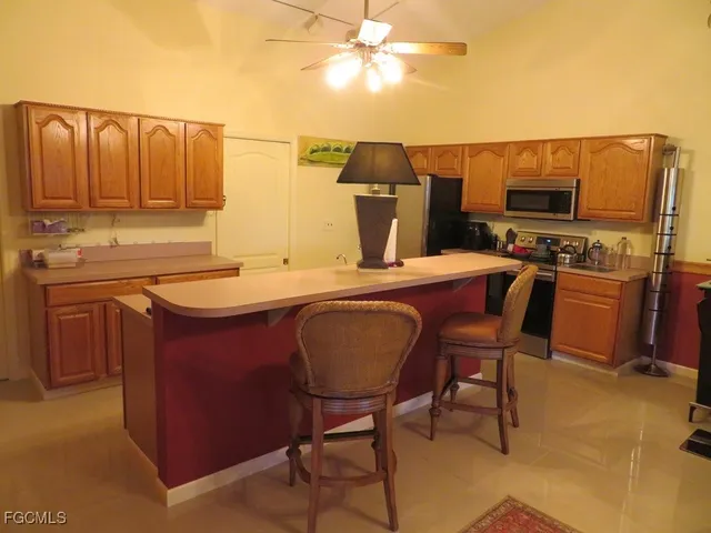 a dining table with chairs and kitchen view