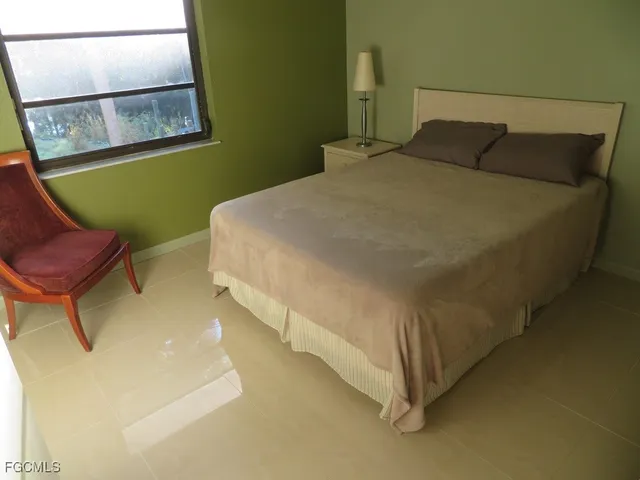 a bed sitting in a bedroom next to a window