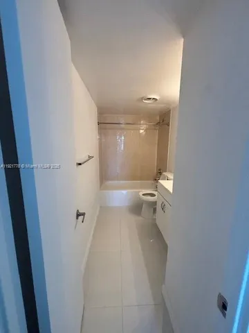 an aerial view of residential building with outdoor space and lake