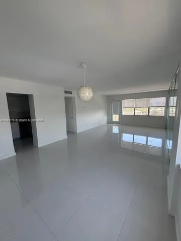 a view of empty room with floor to ceiling window