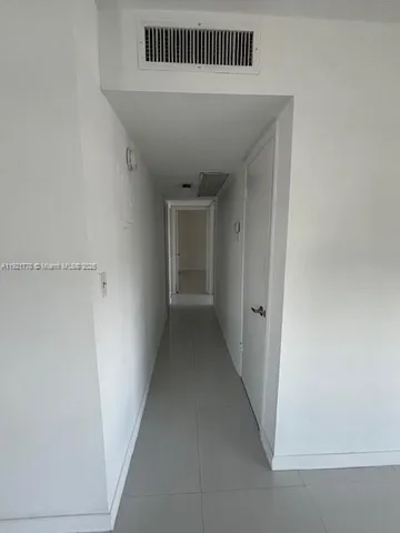 a view of a livingroom with wooden floor and stairs