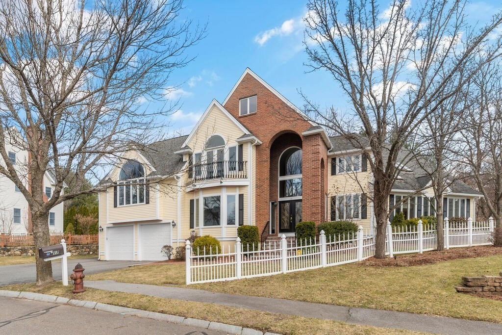 a view of a large house with a yard and large tree