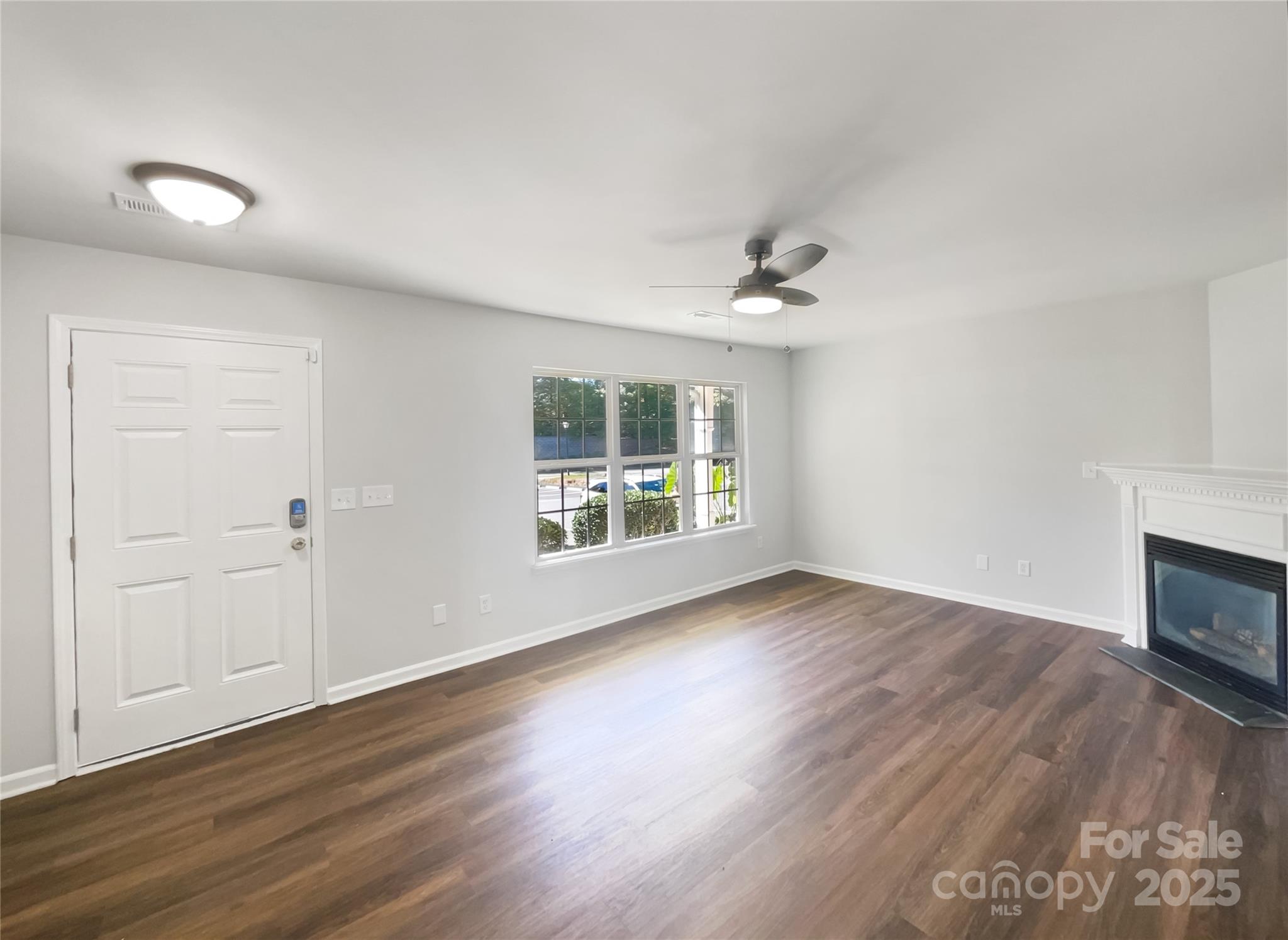 146 Marakery Road, Unit B Mooresville, NC 28115 - Photo 11 of 19 a view of an empty room with wooden floor and a window