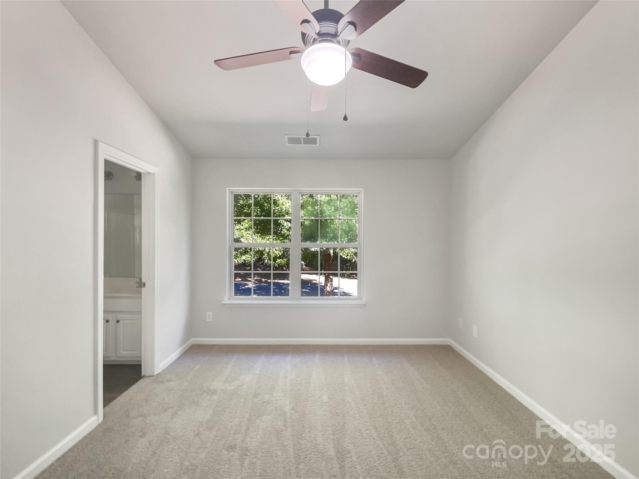 146 Marakery Road, Unit B Mooresville, NC 28115 - Photo 15 of 19 an empty room with a window and a fan