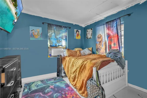 a bedroom with a bed and a ceiling fan