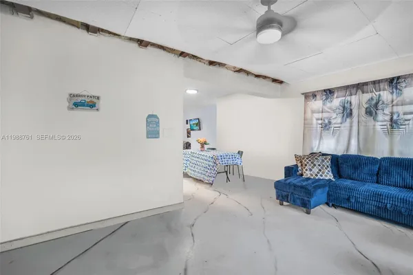 a living room with furniture and a lamp