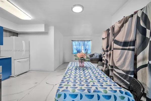 a kitchen with stainless steel appliances granite countertop a refrigerator sink and stove